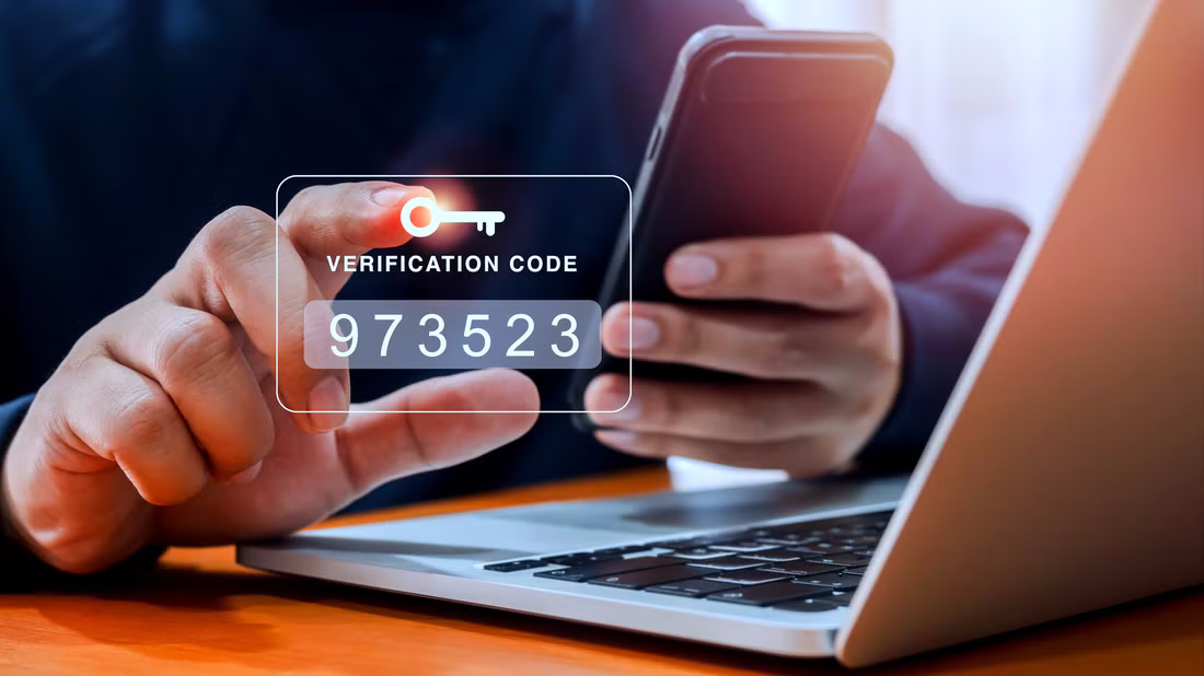 Man entering two factor authentication code on smartphone